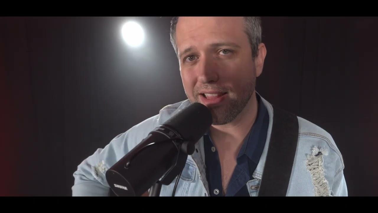 Kyle Head performing under a single spotlight in the music video “Nothing Else”